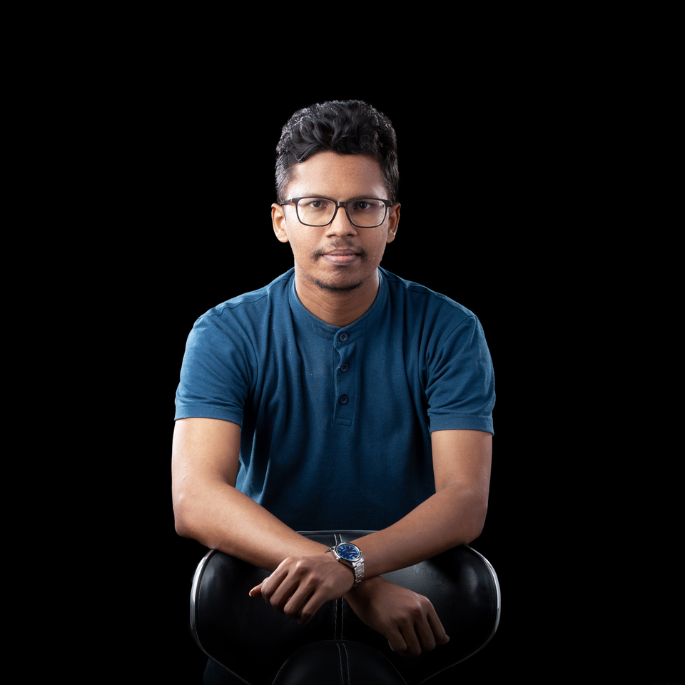 Udara Sandesha wearing glasses and a blue shirt